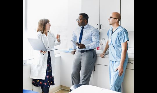 Physician meeting with staff