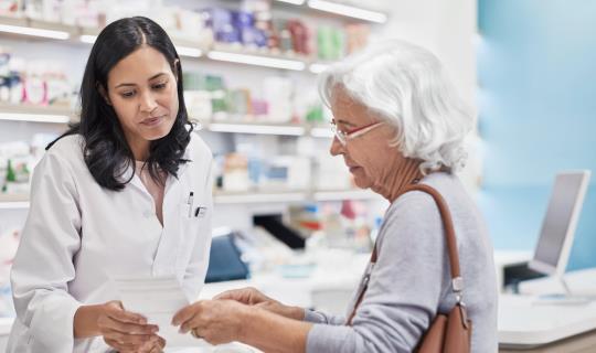 in office pharmacist helps patient